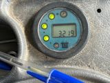 a close up of a blue toothbrush in front of a gauge