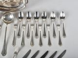 a lot of silver spoons and silverware on the table
