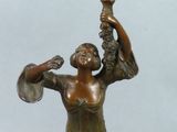 a bronze statue of a woman holding a bird