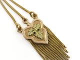 a close up of a necklace with a heart on it