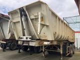 a dump truck that is parked on the side of the road