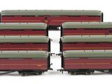 six red and green train cars sitting next to each other