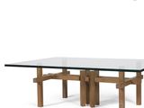 a glass table with wooden legs and a glass top