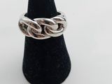 a close up of a silver ring on a black cone