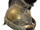 a gold helmet with a black feather on top of it