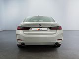 the rear of a white bmw 6 series sedan parked in a room