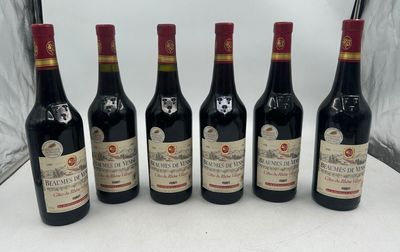 six bottles of wine are lined up on a table