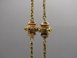 pair of gold plated earrings with green glass beads hanging from them