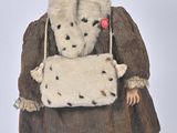a doll that is dressed in a coat and hat