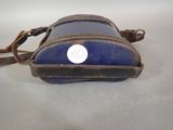 a small blue bag with a white tag on it
