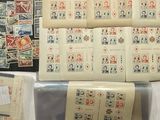 a lot of stamps on a table with a sheet of paper