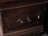a wooden dresser with a mirror on top of it