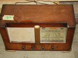an old radio sitting on the floor in a room