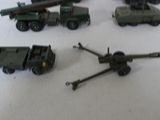 several toy army vehicles are lined up on a white surface