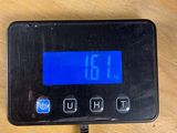 a digital clock that is on a table