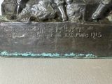 a bronze statue of a group of people sitting on a bench