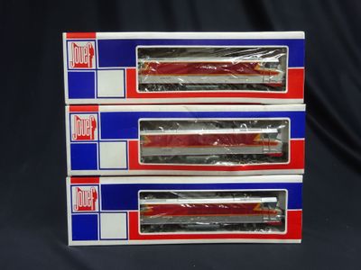 three red and blue train cars are stacked on top of each other