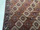 an image of a brown and blue rug on a white floor