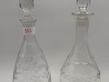 pair of clear glass decanters on white surface with white background
