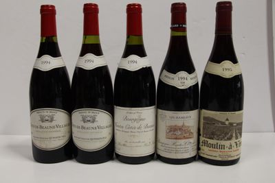 six bottles of red wine are lined up on a table