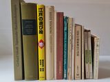 a lot of books that are stacked up on a table