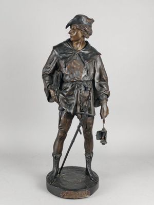 a bronze statue of a man with a hat and a cane