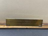 a close up of a metal plaque on a black surface