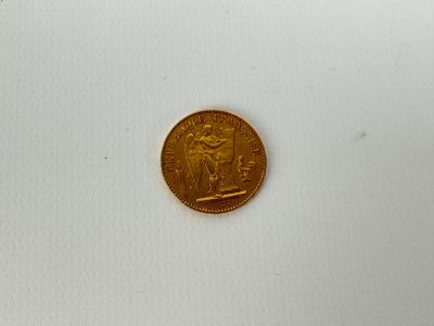 an image of a gold coin sitting on top of a white surface