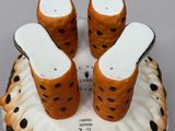 three salt and pepper shakers sitting on top of a cookie