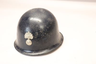 a helmet with a cross on it sitting on a table
