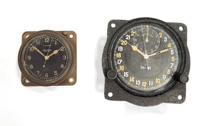 two clocks that are sitting next to each other on a table