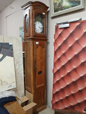 a grandfather clock in the corner of a room next to a painting