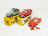three small toy cars sitting on top of a box