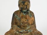 une image représentant une statue de Bouddha assis sur une surface blanche