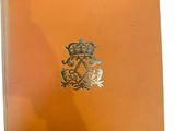 an orange book with a crown on the front of it