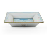 a blue and white bowl with a picture of a beach scene on it