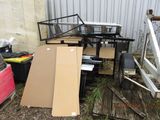 a pile of boxes and other items outside of a building
