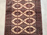 rug on the floor is brown and tan with a pattern on it