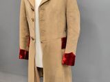 an image of a beige coat with red trims on a mannequin