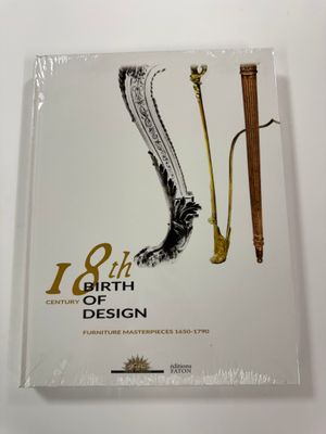 an image of a book on a white table with a gold and black design