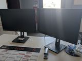 a desk with two monitors and a calendar on it