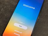 a close up of a phone with a welcome screen on it