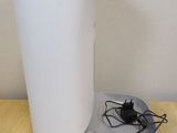a white cup sitting on a table next to a charger