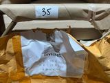 a yellow chair with a paper bag on it and a brown chair with a paper bag on the back of it