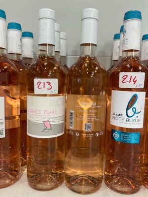 several bottles of wine are lined up on a shelf