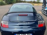 a picture of a blue porsche parked in a parking lot