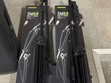 two black tripods sitting next to each other on the floor