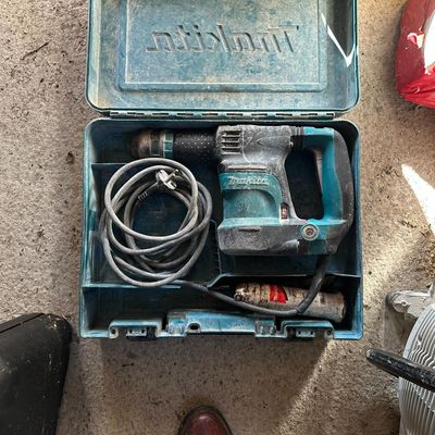 a blue tool box with tools in it on the ground