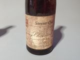 a bottle of wine sitting on a table next to a bottle of wine