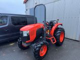 an image of a red tractor parked in front of a building